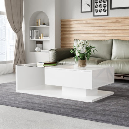 Modern living room with a white coffee table, grey sofa, and decorative elements.