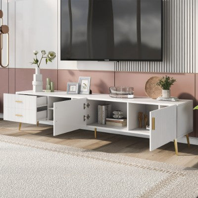 Modern white entertainment console with a television mounted above it, featuring decorative items.