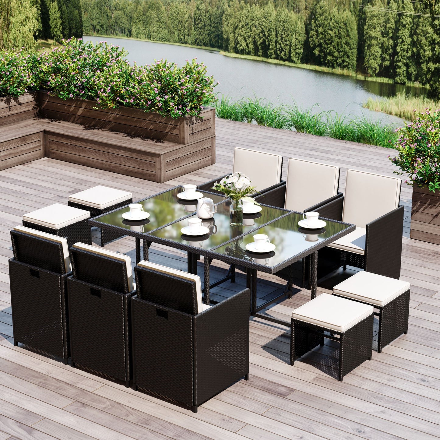Outdoor patio furniture set with a table and chairs on a wooden deck by a body of water.